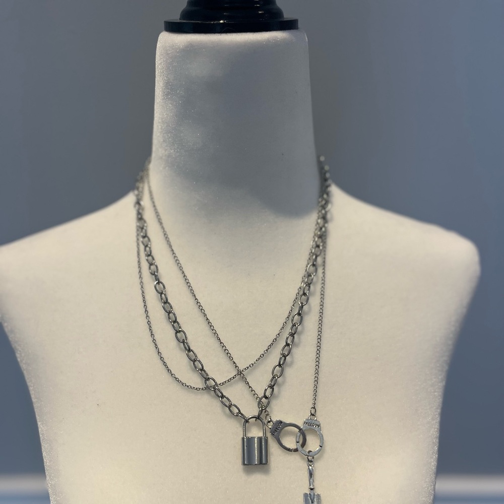 3 silver necklace bundle, lock, handcuffs and plain chain, shovel